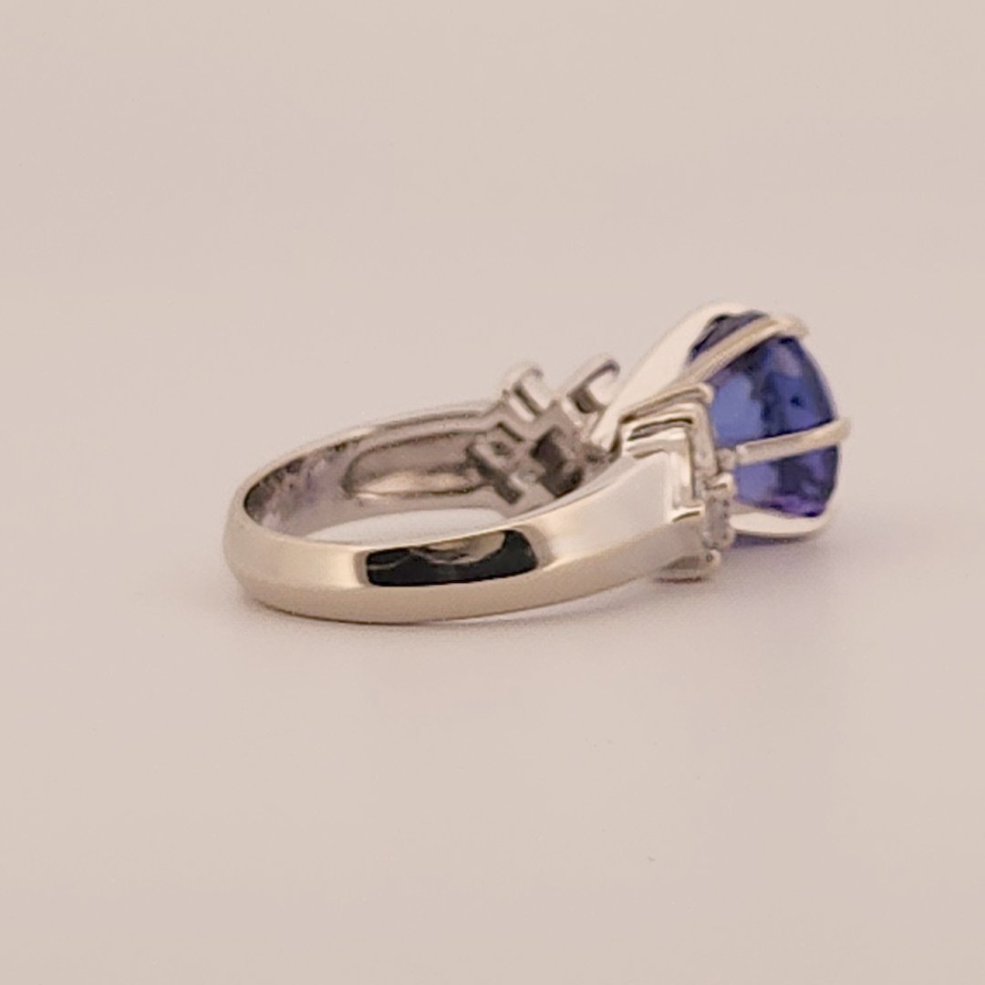Natural Round Modified Brilliant Cut, Bluish Violet Tanzanite (5.25 CT - 10.20 mm) with 12 Natural Princess cut 3x3 mm Square Diamonds (1.92 CTW) Ring 14K White Gold. GIA Certified (2231466864).