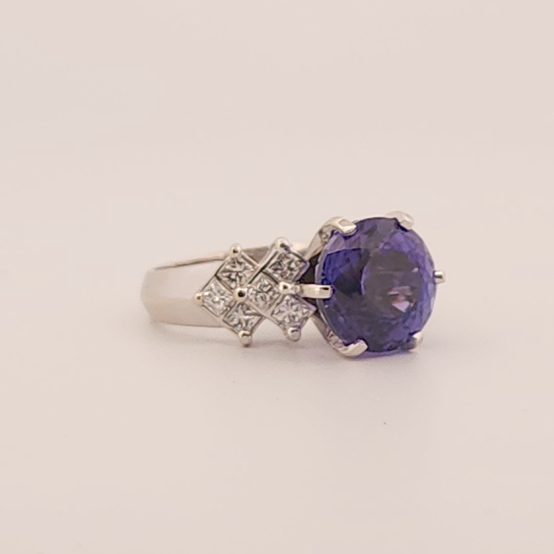 Natural Round Modified Brilliant Cut, Bluish Violet Tanzanite (5.25 CT - 10.20 mm) with 12 Natural Princess cut 3x3 mm Square Diamonds (1.92 CTW) Ring 14K White Gold. GIA Certified (2231466864).