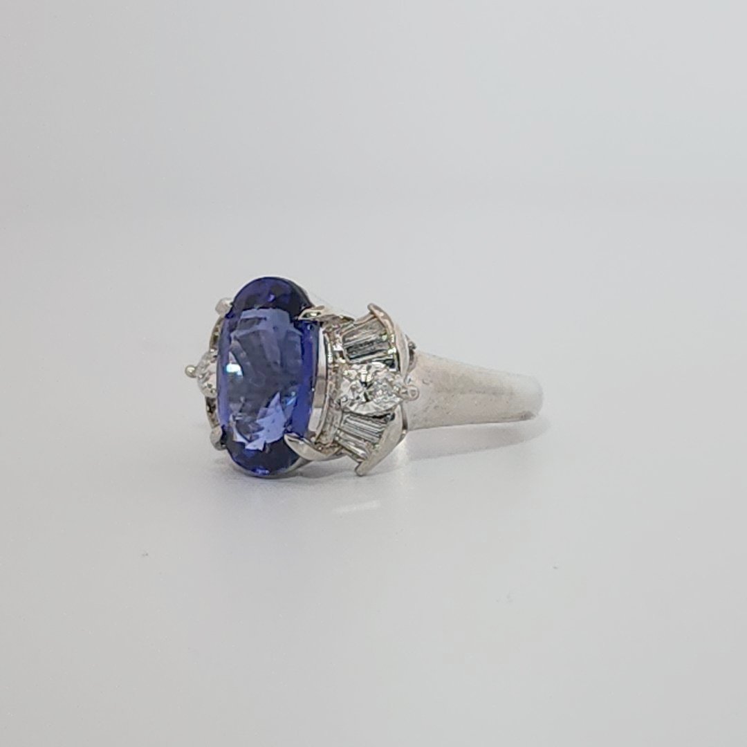 Modified Brilliant Cut, Oval Shape, Bluish Violet Tanzanite (4.38CT, 12.77 x 8.29 x 5.57 mm), Mounted at Platinum 900 Ring with Natural Diamonds (0.60 CTW, E/F-VS). GIA Certified (5232466621). Size 5.75