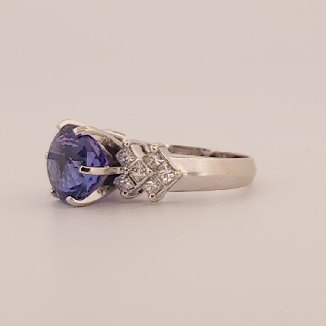 Natural Round Modified Brilliant Cut, Bluish Violet Tanzanite (5.25 CT - 10.20 mm) with 12 Natural Princess cut 3x3 mm Square Diamonds (1.92 CTW) Ring 14K White Gold. GIA Certified (2231466864).